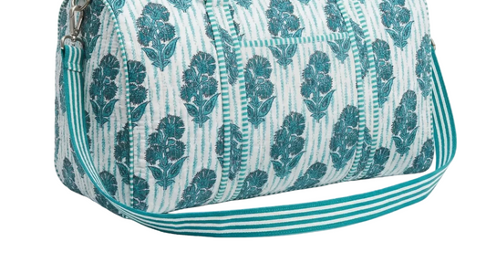 Teal floral patterned handbag on a white background