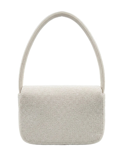 A small rectangular shoulder bag with a rounded bottom and a single arched strap, covered in a tightly woven textured fabric. The bag is a light warm off-white/cream color, photographed against a white studio backdrop with soft light reflections.