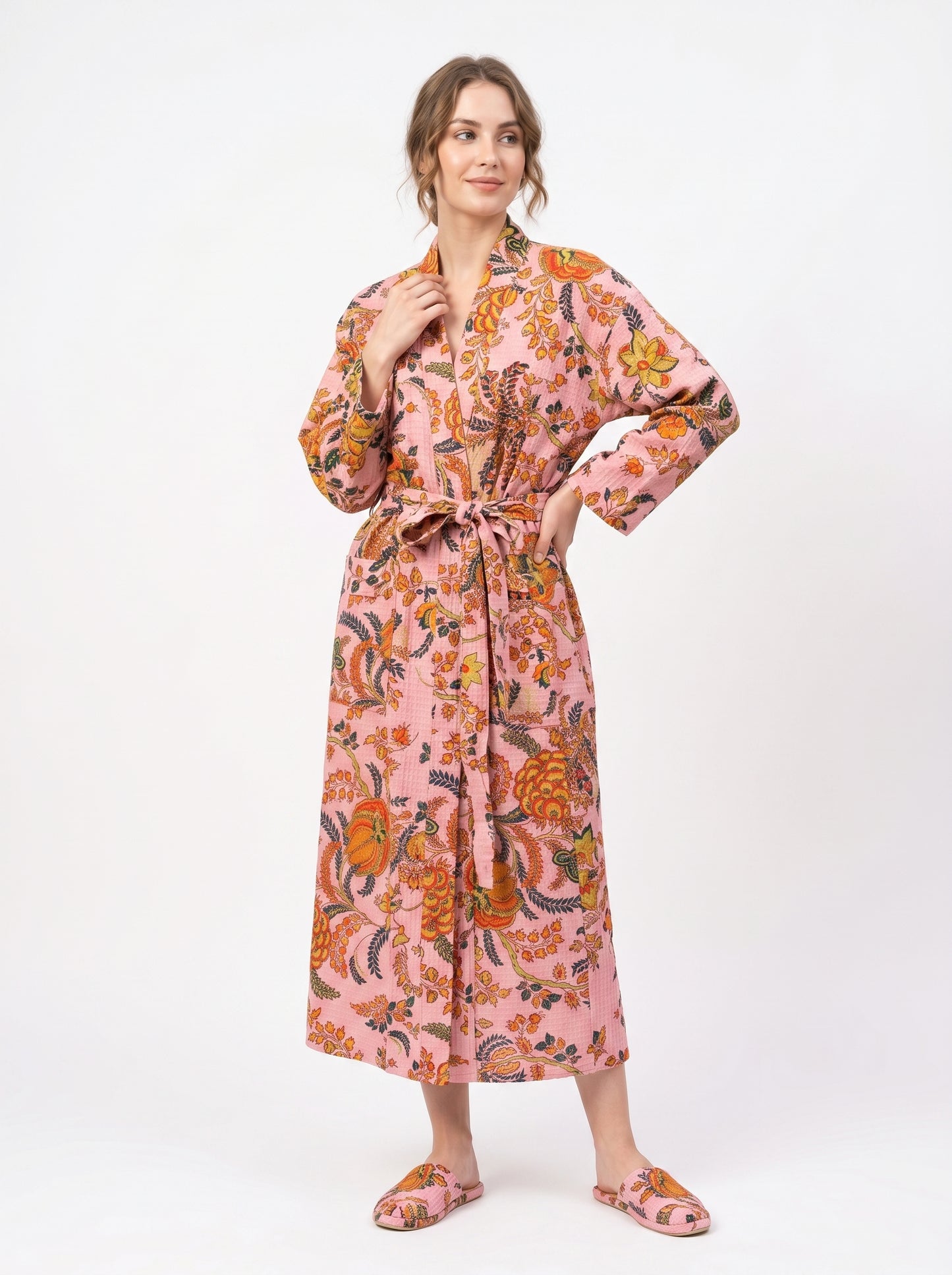 Woman wearing a floral patterned robe on a white background